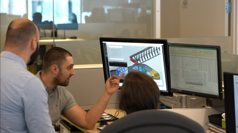 Engineers collaborating on a numerical simulation project, showcasing teamwork and advanced expertise to drive innovation and efficiency in product engineering and development.